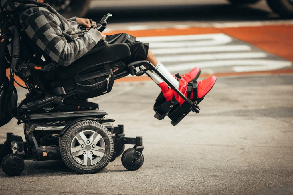kid strapped into motorised wheelchair