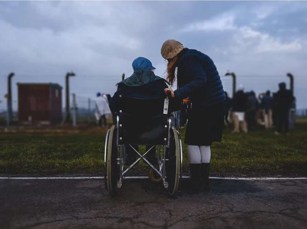 assisting man in wheelchair